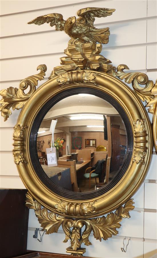 A William IV gold painted giltwood convex wall mirror, with eagle surmount H.90cm